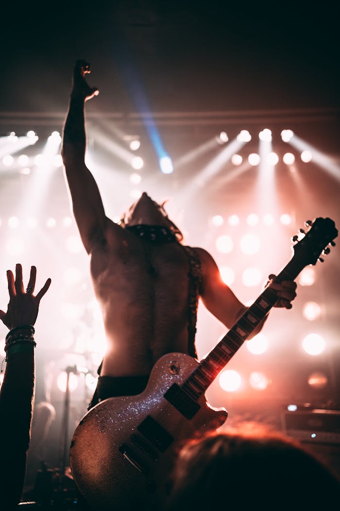 Dynamic stage performance of a guitarist during a live rock concert.
