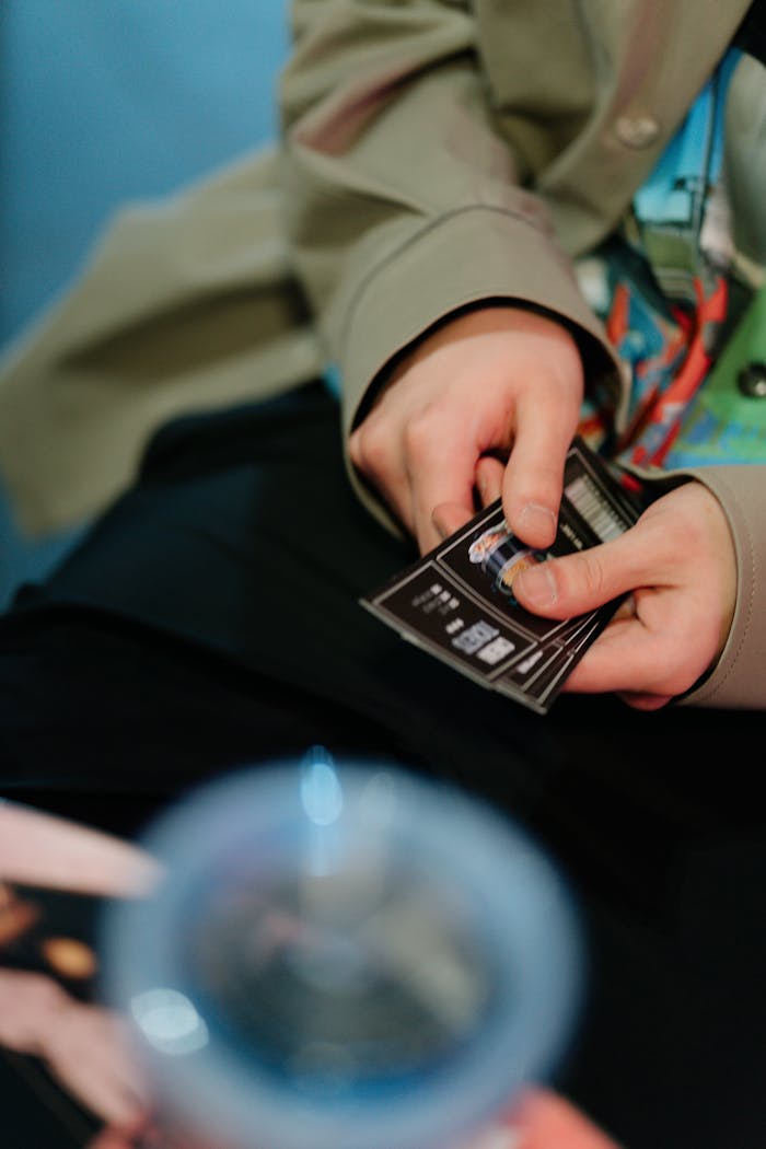 Close-up of hands holding cinema tickets, capturing a moment of anticipation for movie enthusiasts.